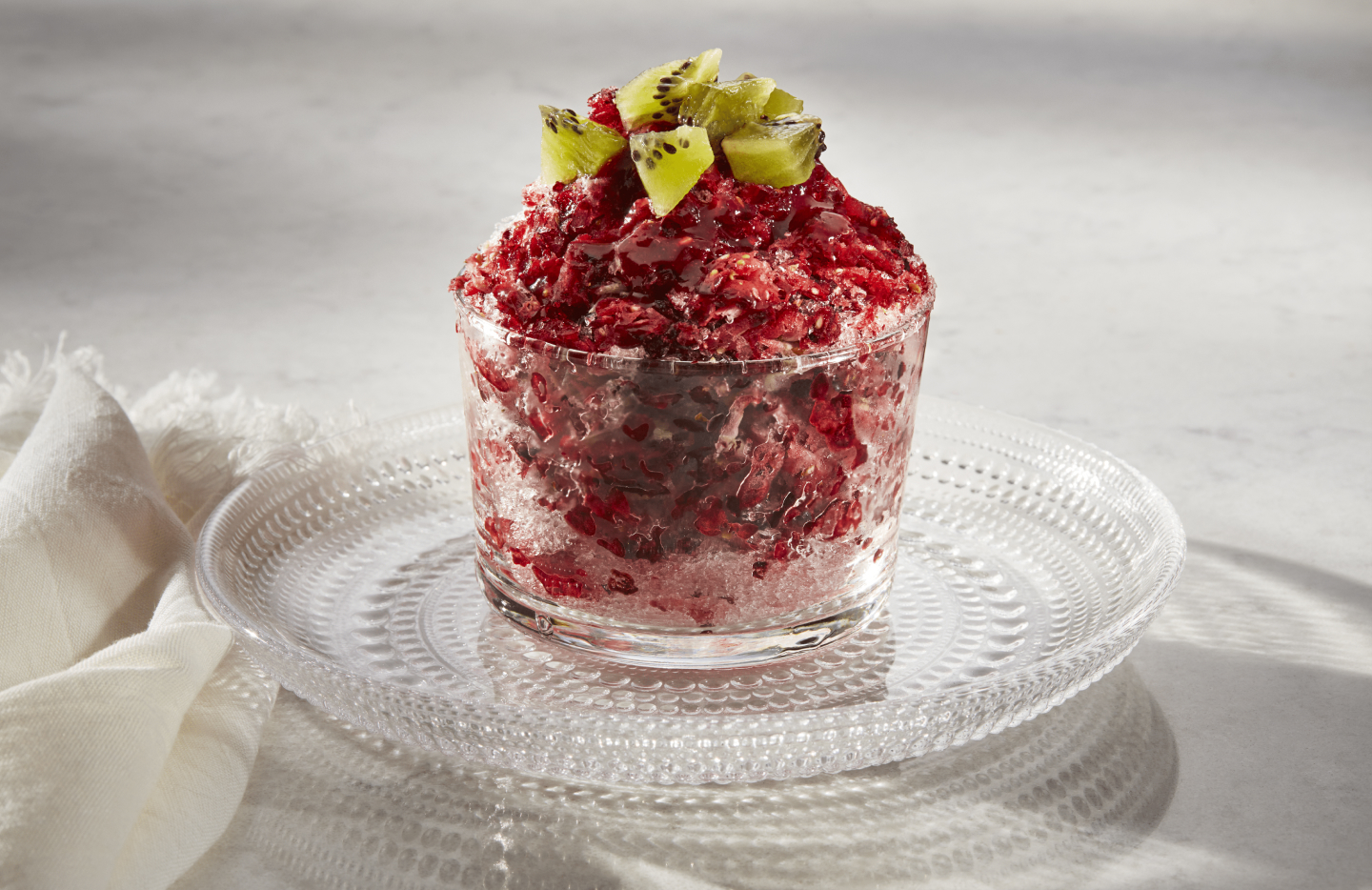 Shaved ice dessert with fruit syrup and fruit